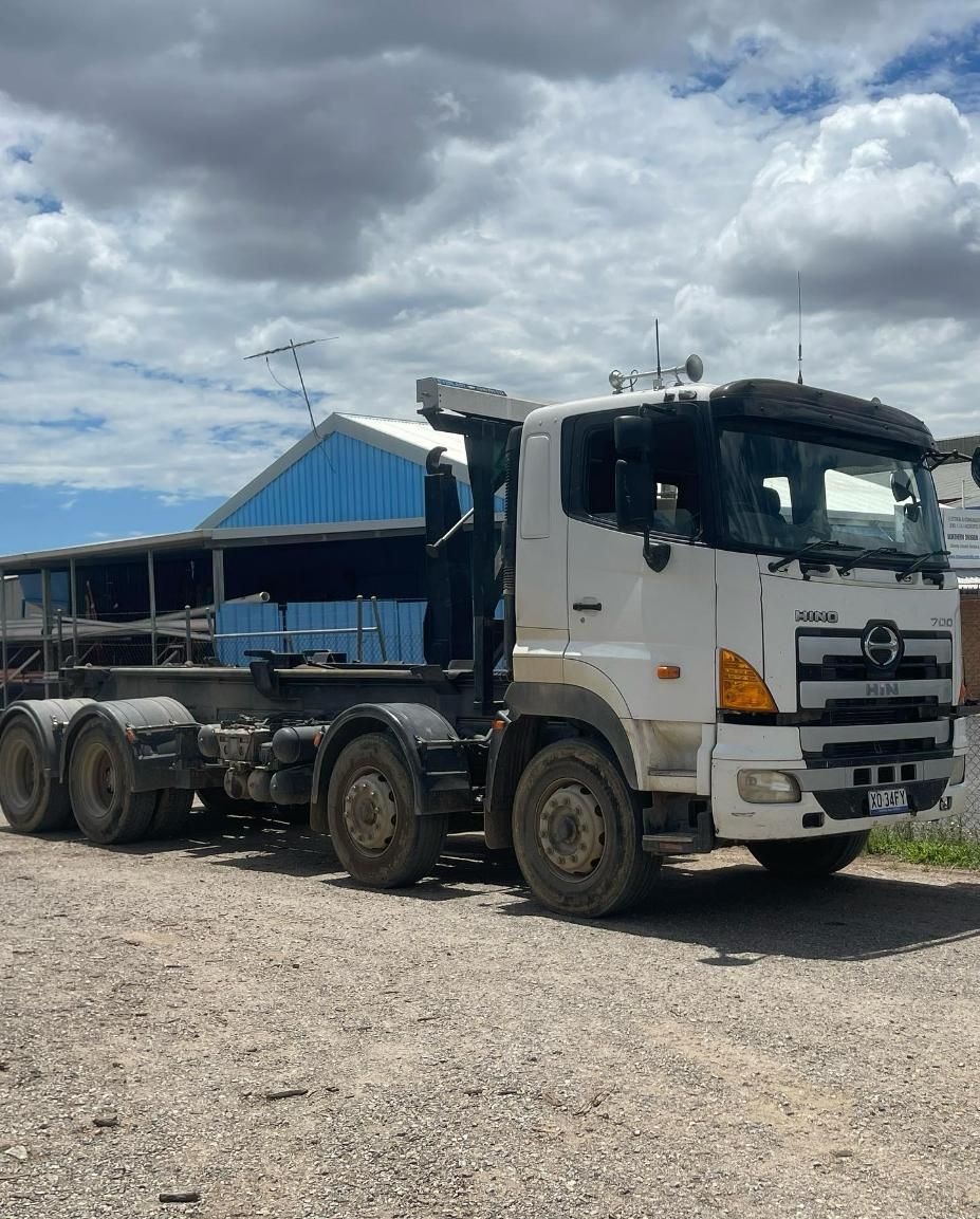 A White Semi Truck Is Parked In A Gravel Lot In Front Of A Building — Tamworth Skip Eze In Taminda, NSW