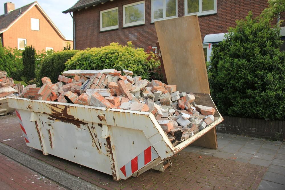 A Dumpster Filled With Bricks Is On The Side Of The Road In Front Of A House — Tamworth Skip Eze In Taminda, NSW