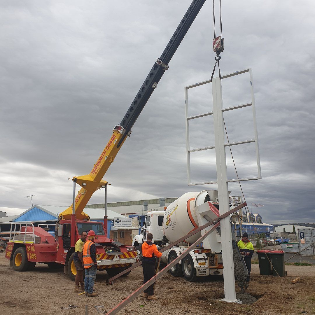 A Concrete Mixer Is Being Used To Pour Concrete Into A Pole — Tamworth Skip Eze In Taminda, NSW