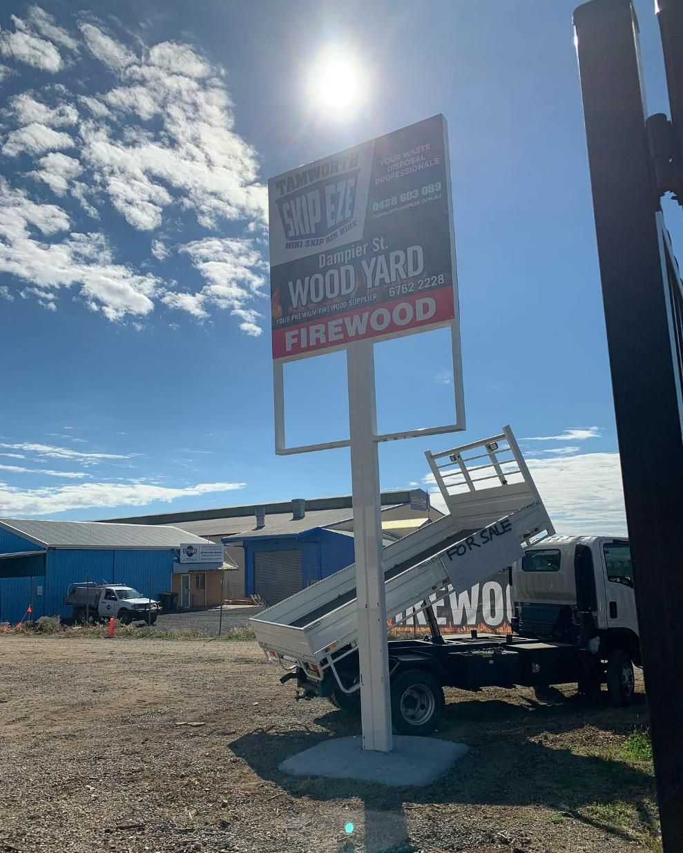 A Dump Truck Is Parked In Front Of A Sign That Says Firewood — Tamworth Skip Eze In Taminda, NSW