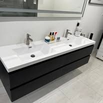 Modern double-sink bathroom vanity with white countertop, black drawers, and wall mirror