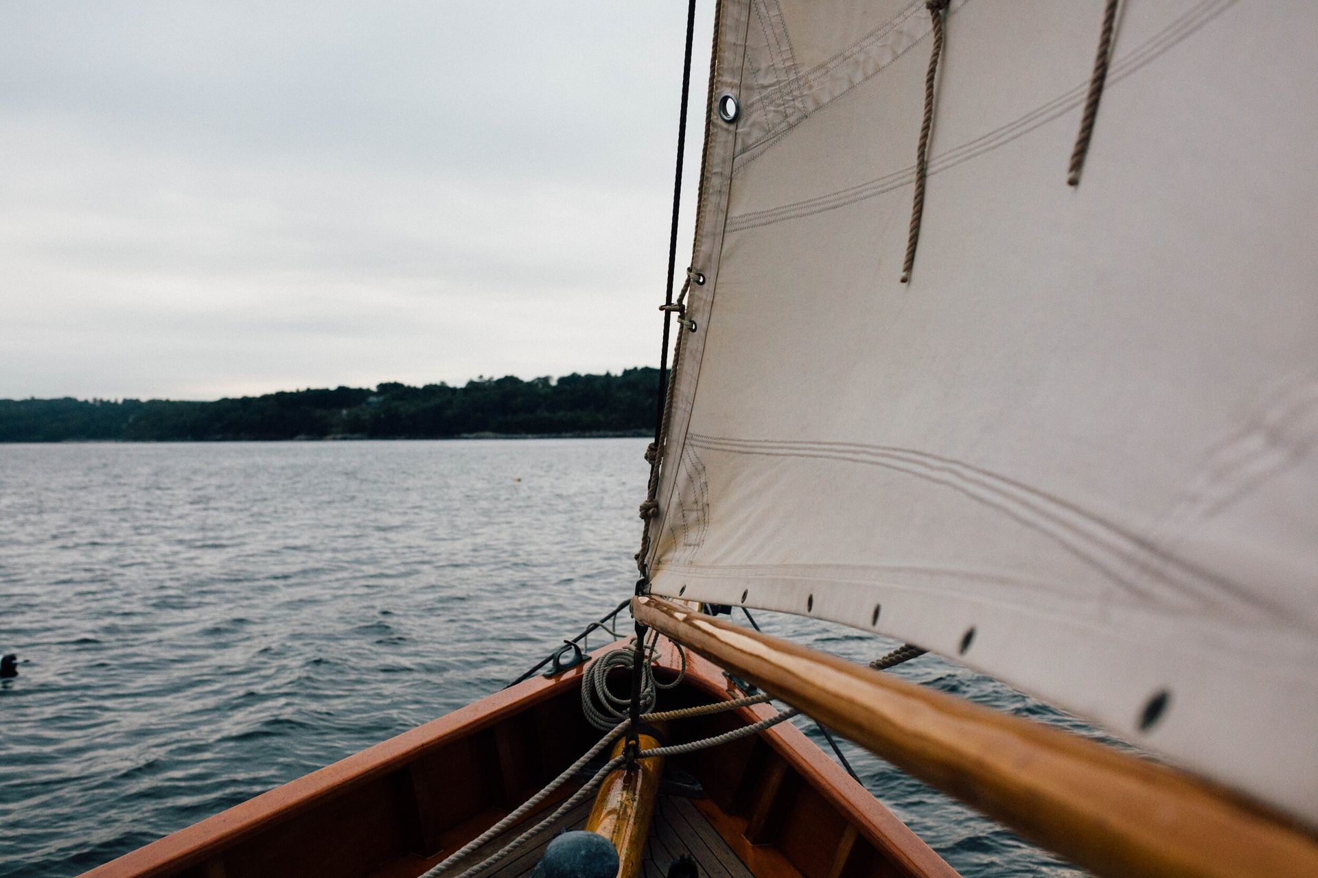 A sailboat is floating on top of a body of water.