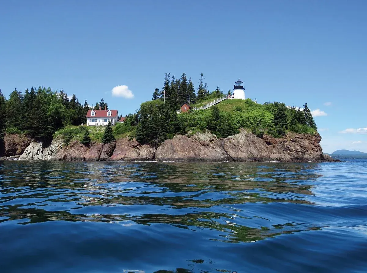A small island with a lighthouse on top of it