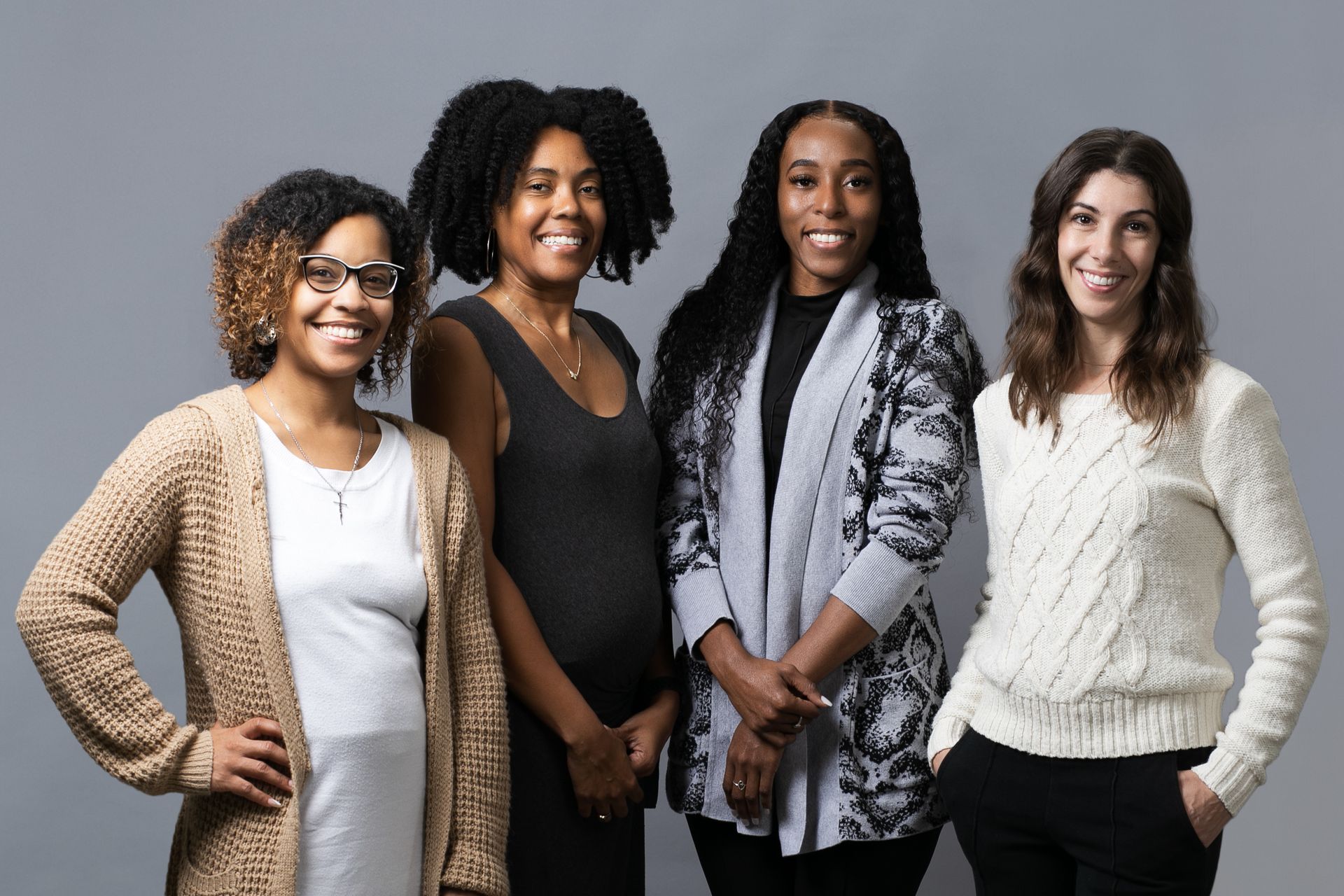 A group of four women are posing for a picture together.
