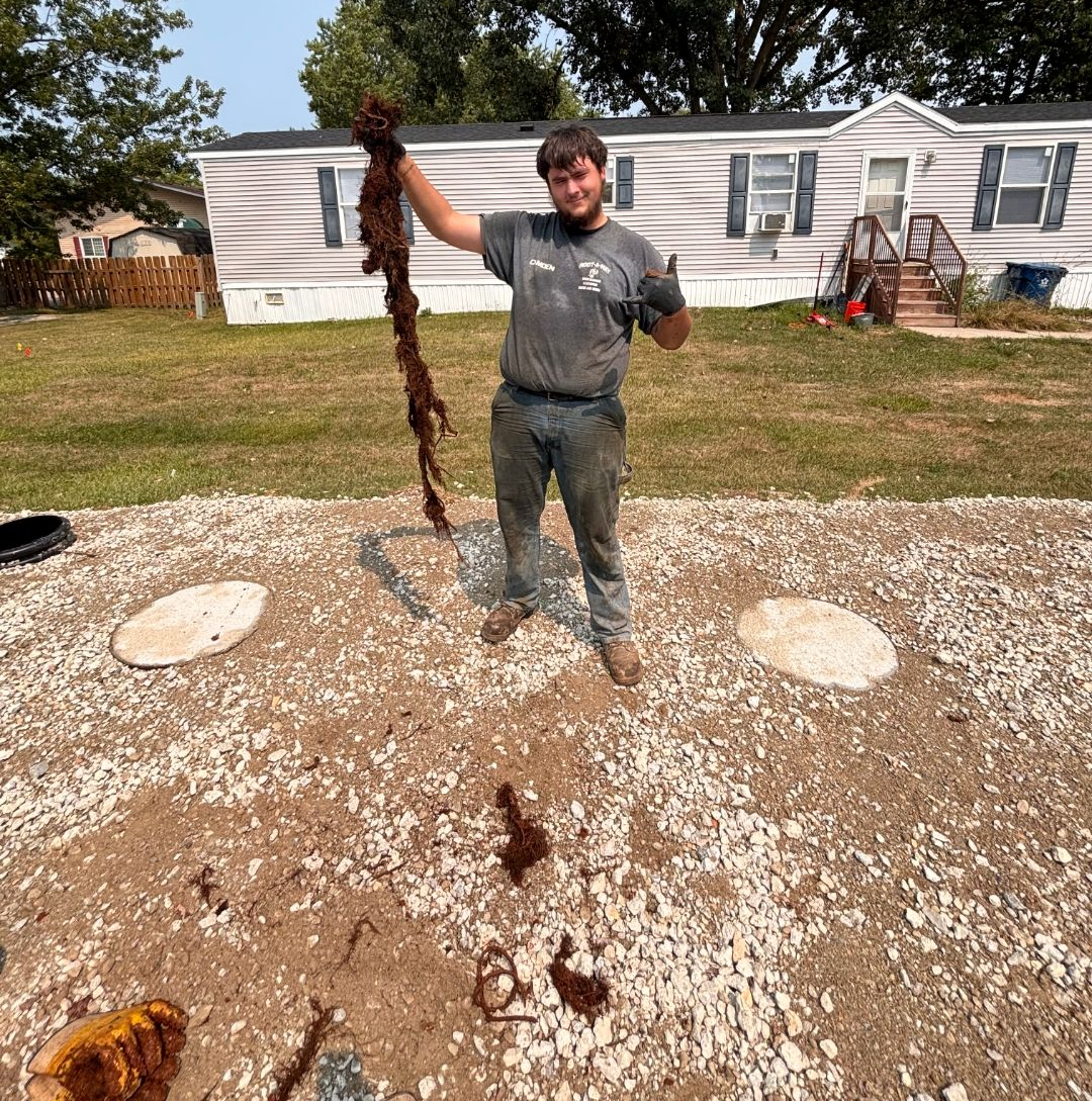 Person digging in muddy soil with a shovel Person digging in muddy soil with a shovel