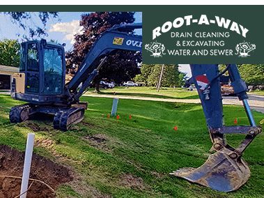 Excavator at a grassy roadside
