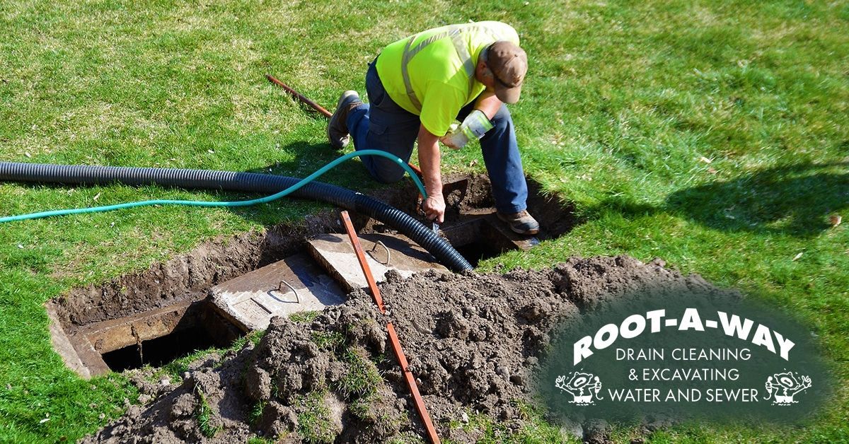 Worker uses hose near a utility trench Worker uses hose near a utility trench