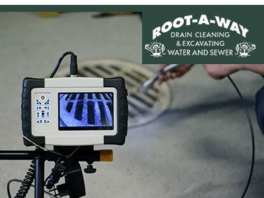 Tablet on tripod showing sewer pipe inspection footage