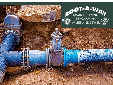 Blue water pipe repair with valve and fittings beside dirt trench