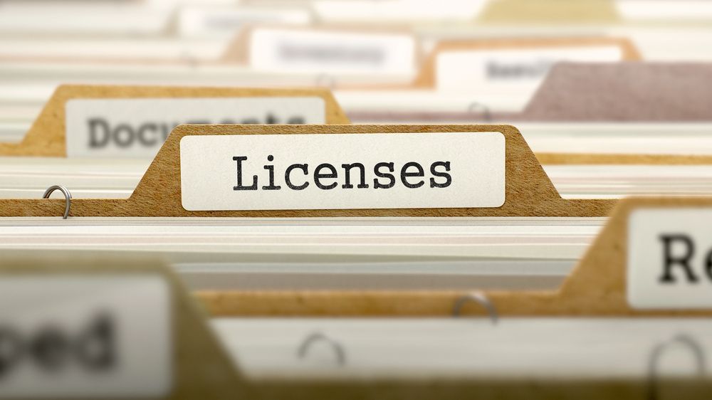 A close up of a file folder with the word licenses written on it.