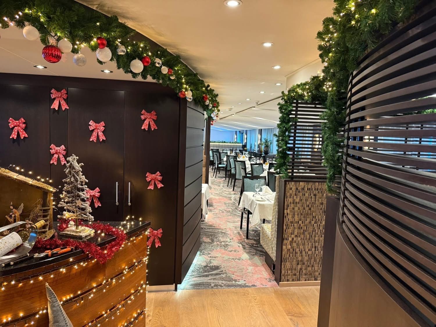 Festive hotel corridor with Christmas decorations, garland, and a decorated reception counter