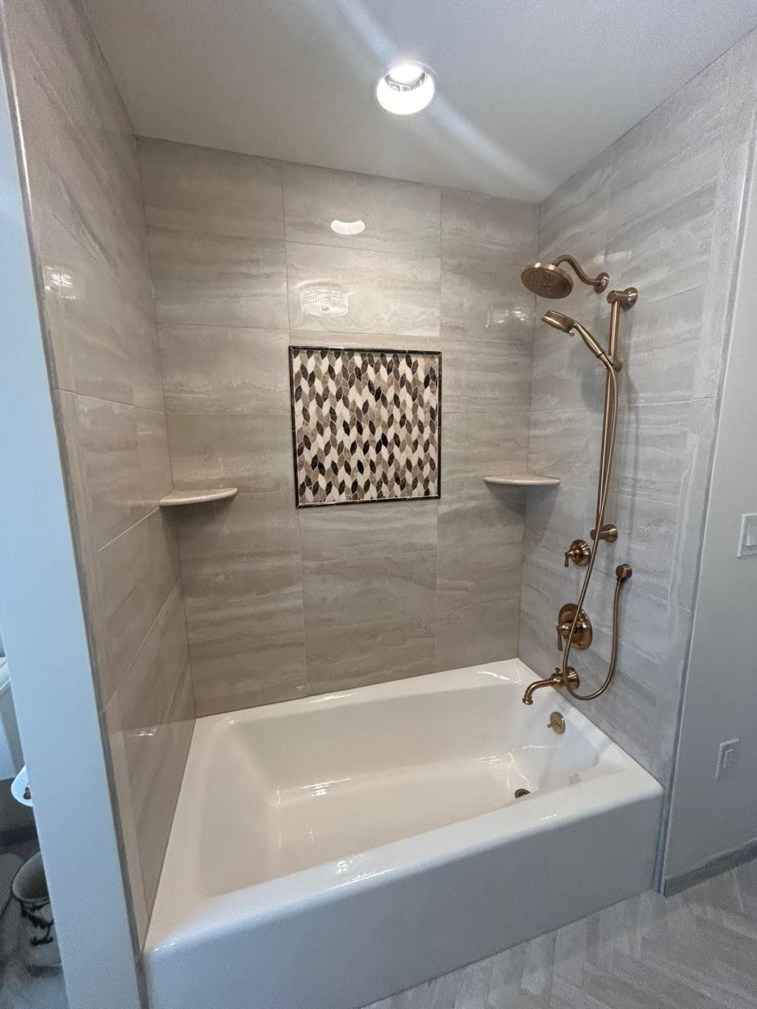 A bathroom with a bathtub and a shower.