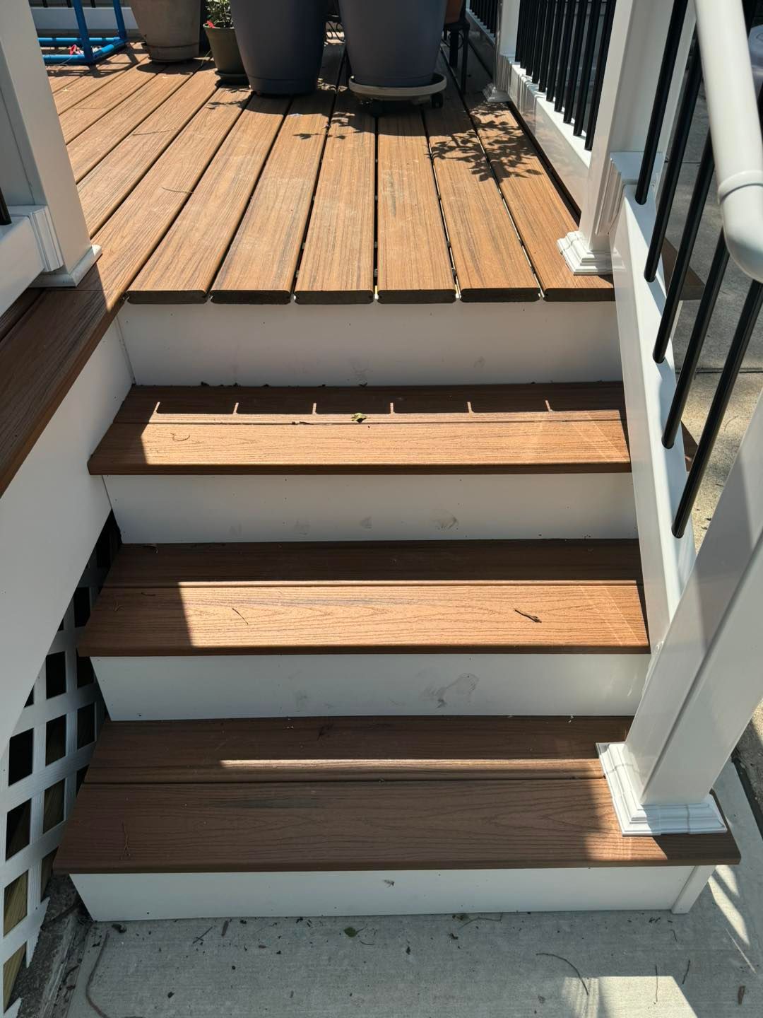 A set of wooden stairs leading up to a deck.