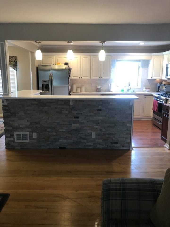 A kitchen with a large island in the middle of the room.