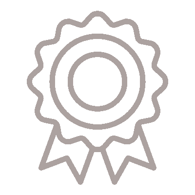 A light brown, line-drawing icon of a circular award badge with scalloped edges and two ribbon tails hanging down.