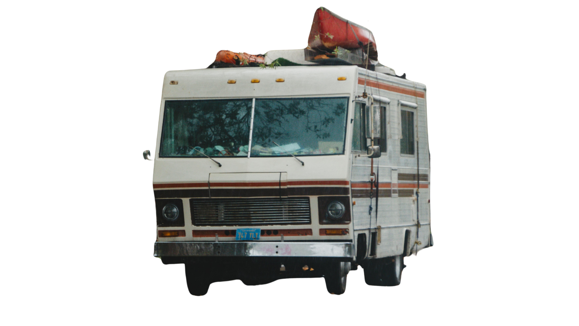 White RV with a red canoe on top, parked on a white background.
