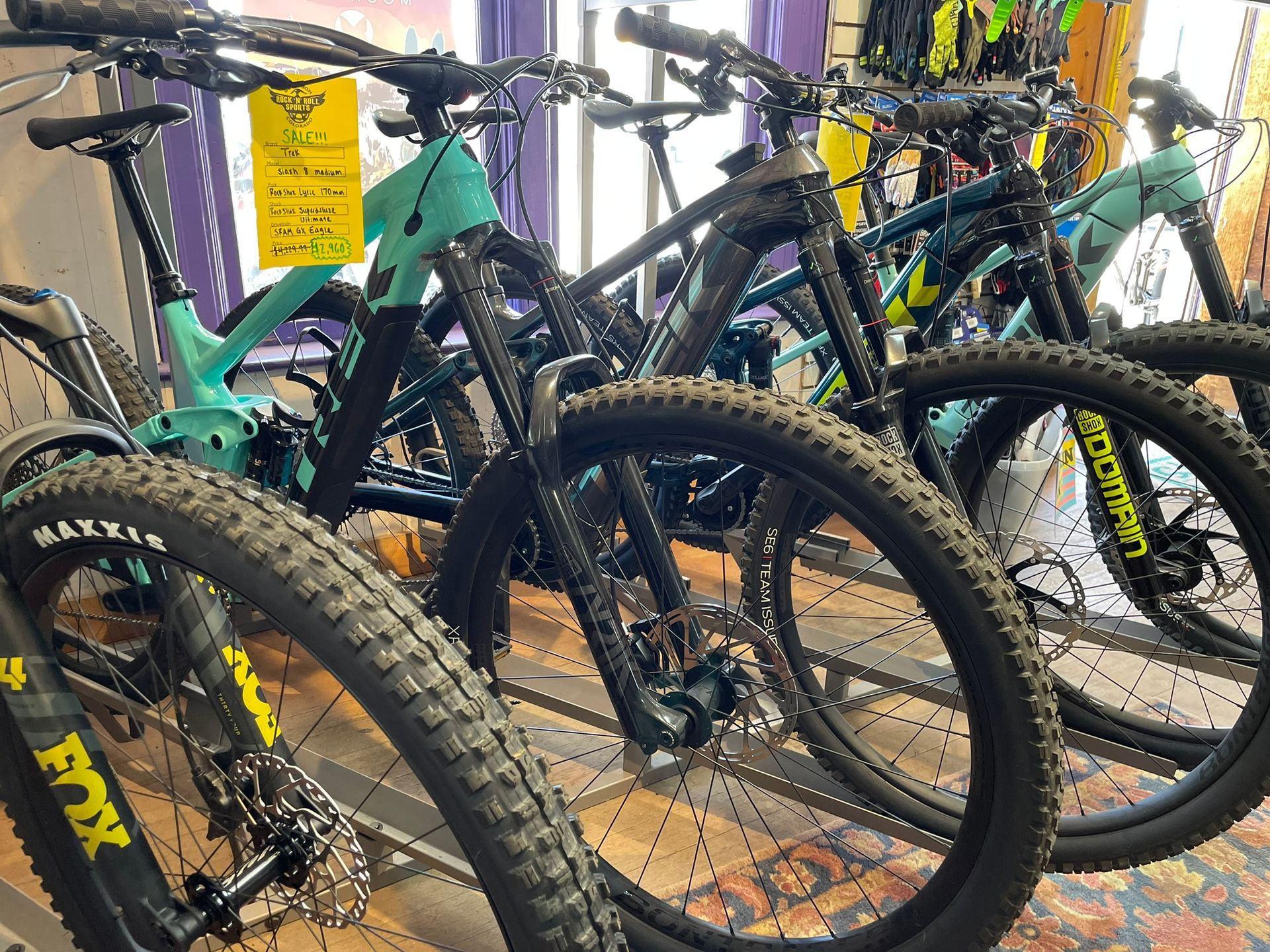 A row of bicycles are lined up in a store.