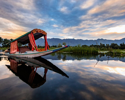 Traditional wooden shikara boat on Dal Lake in Srinagar, Kashmir, India