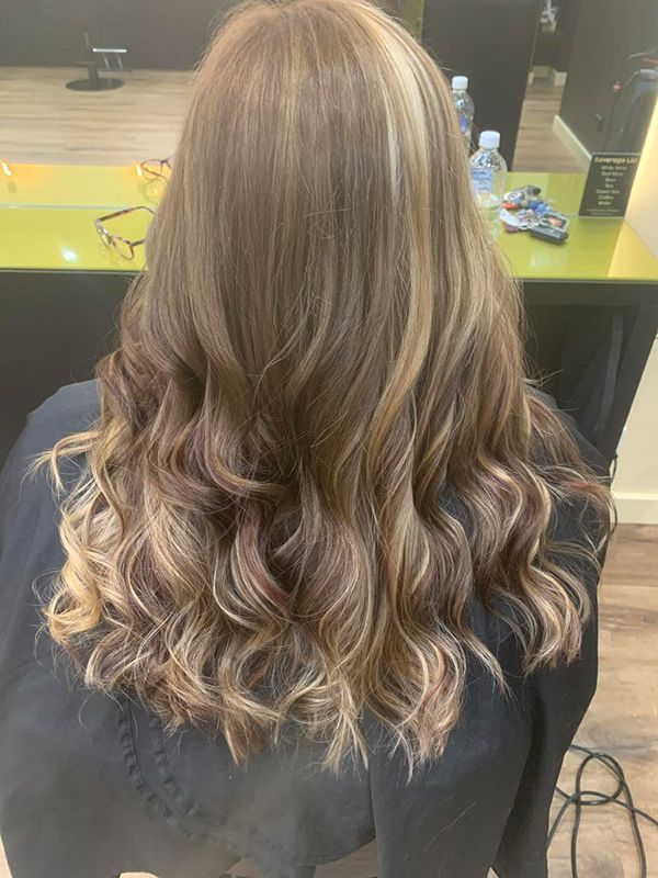 A Woman Is Sitting in A Chair with Her Hair in A Salon — Capello Hair Design in Port Macquarie, NSW