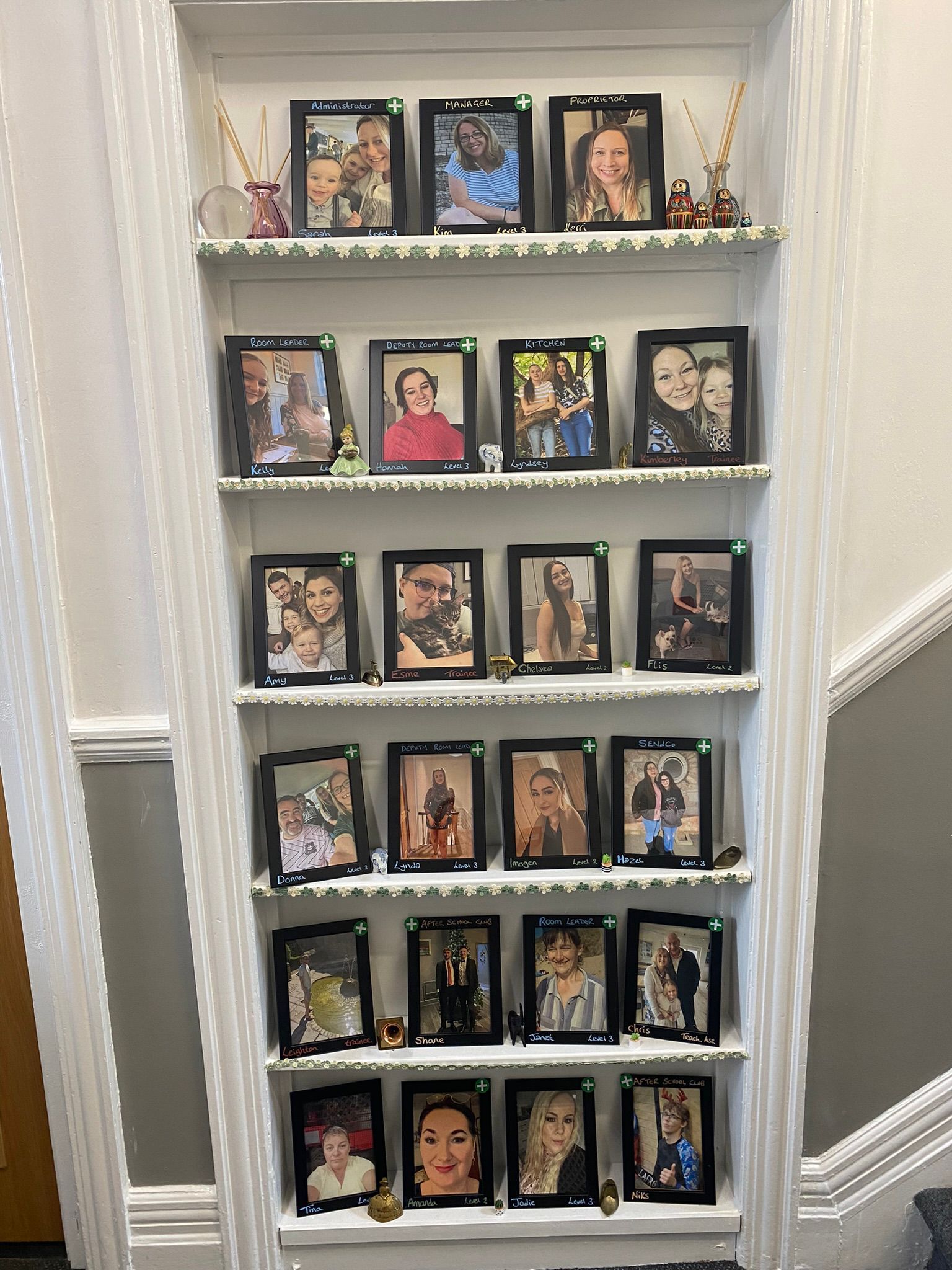A shelf filled with lots of pictures on it
