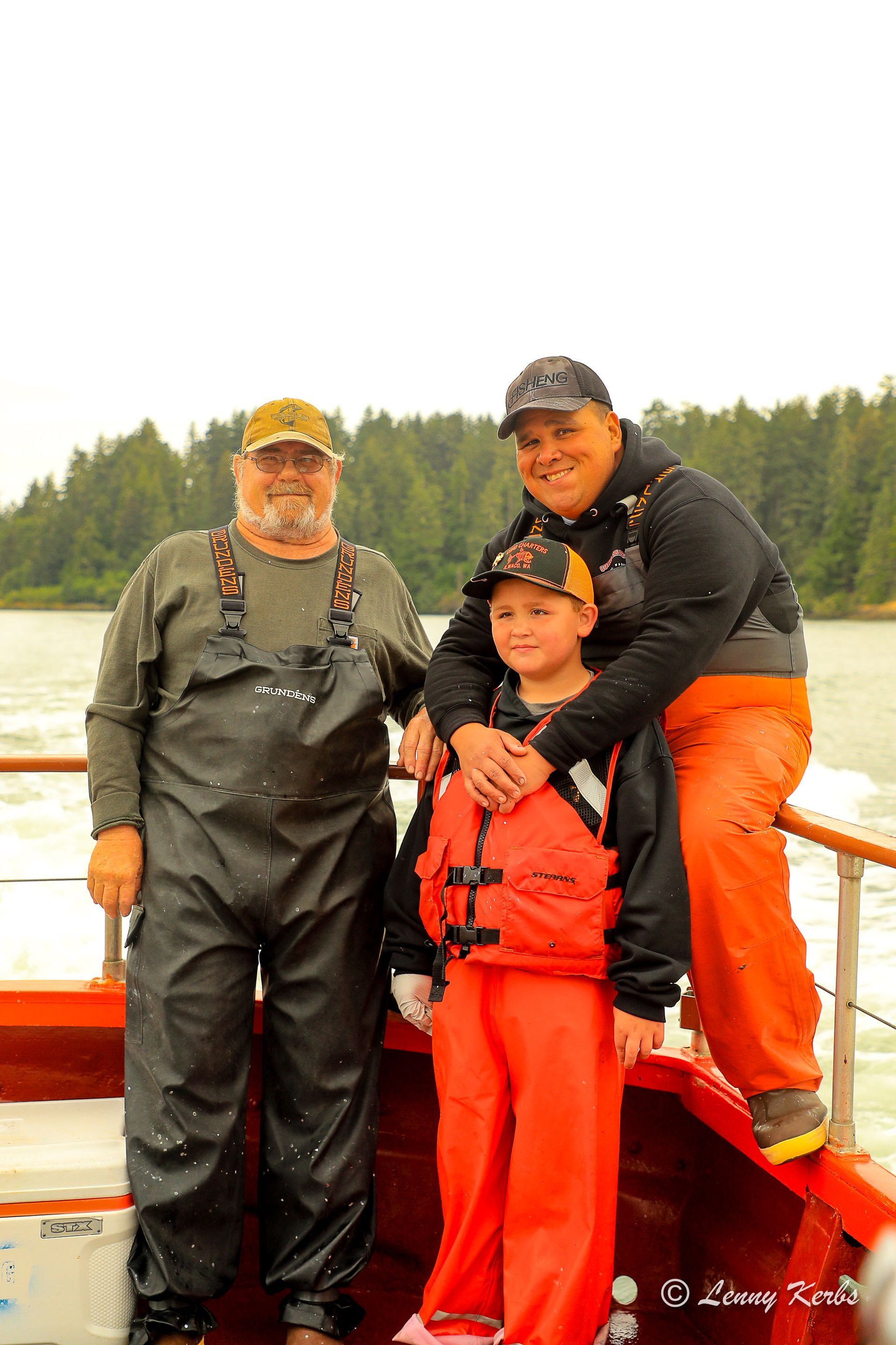Three men are posing for a picture on a boat.