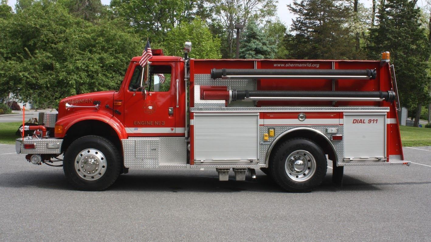 A red fire truck is parked on the side of the road
