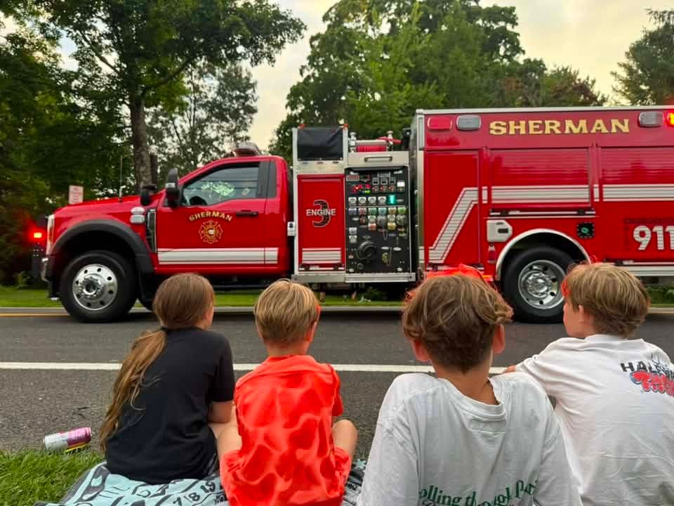 A red fire truck is parked on the side of the road