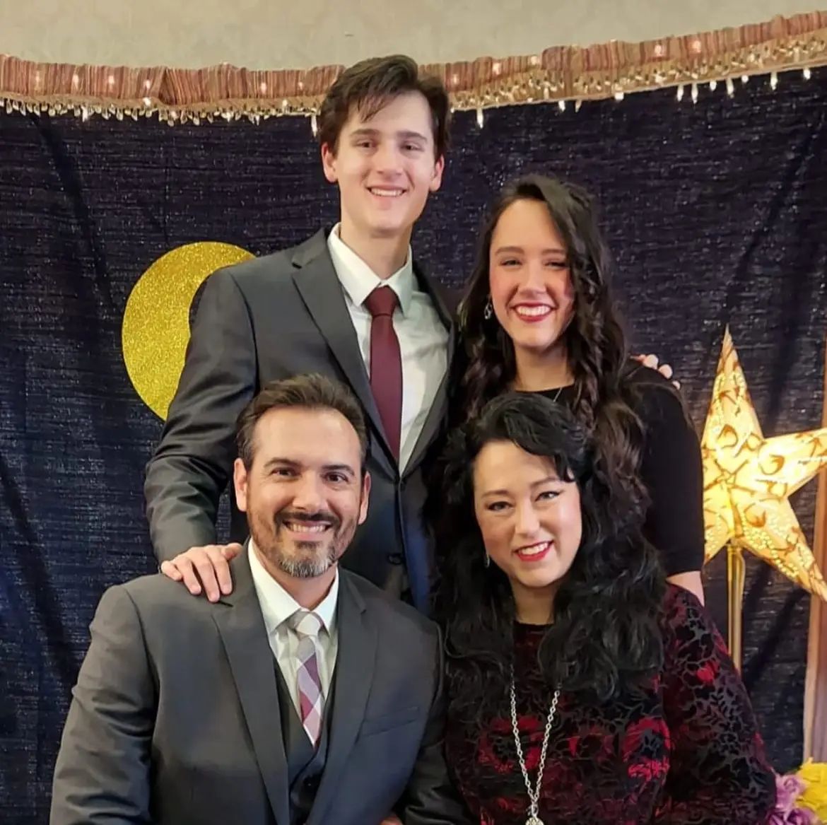 A group of people posing for a picture with a star in the background