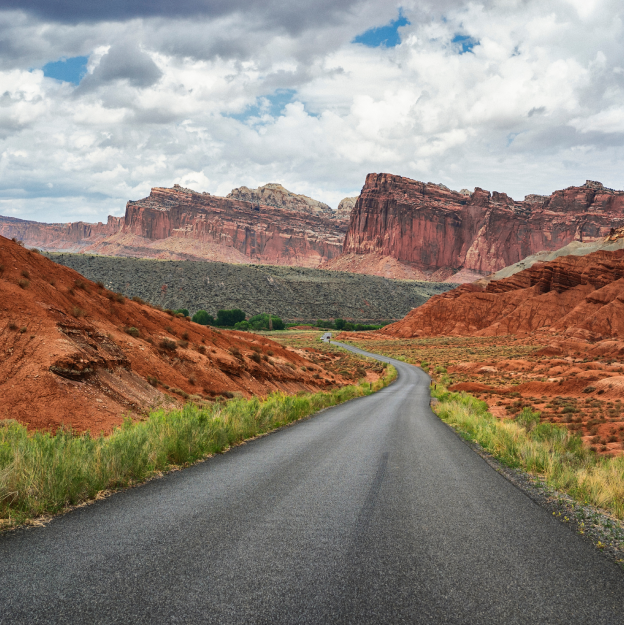 A road in the desert with mountains in the background