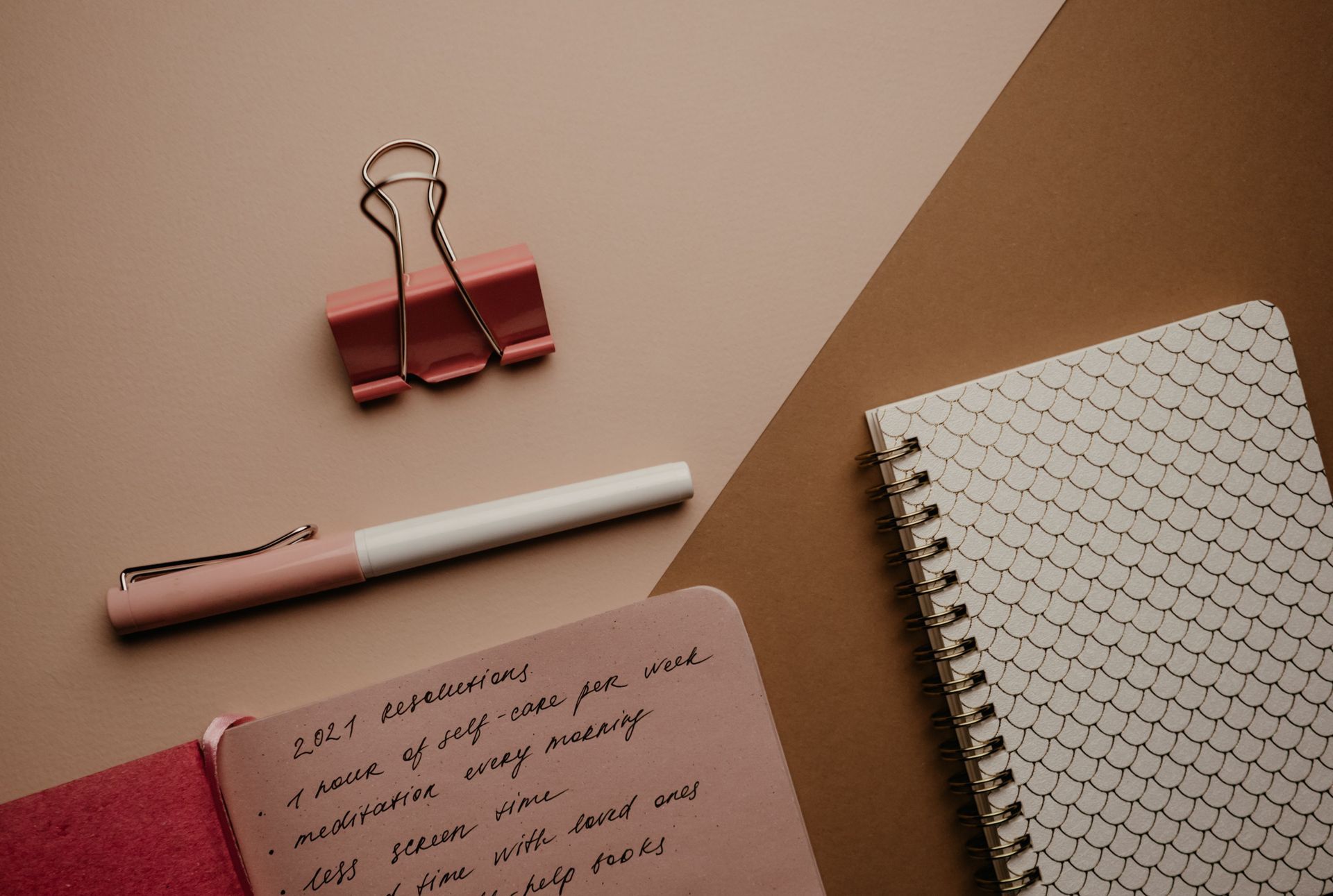 Notebook, pen, and office supplies on a desk
