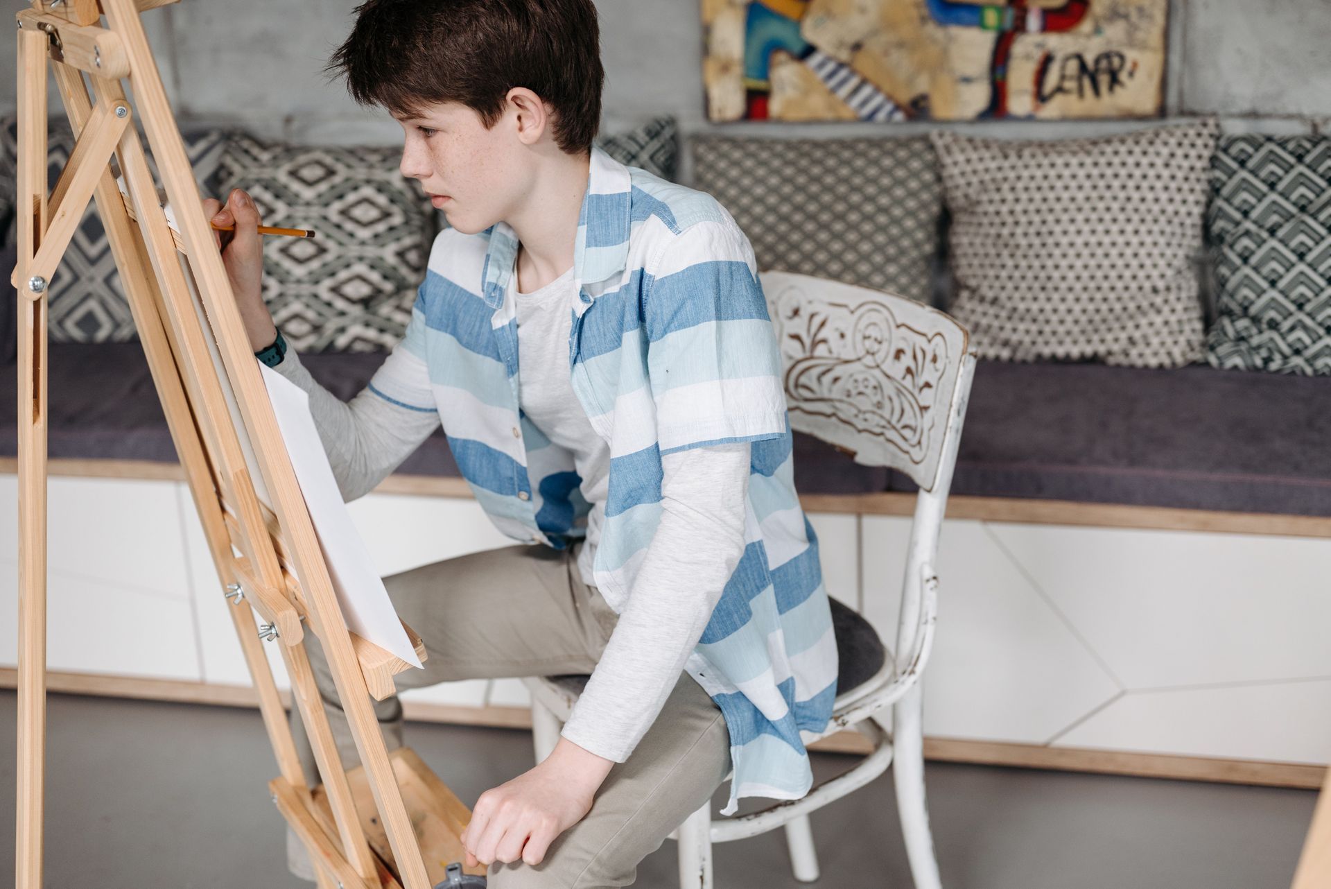 A youth painting  on an easle