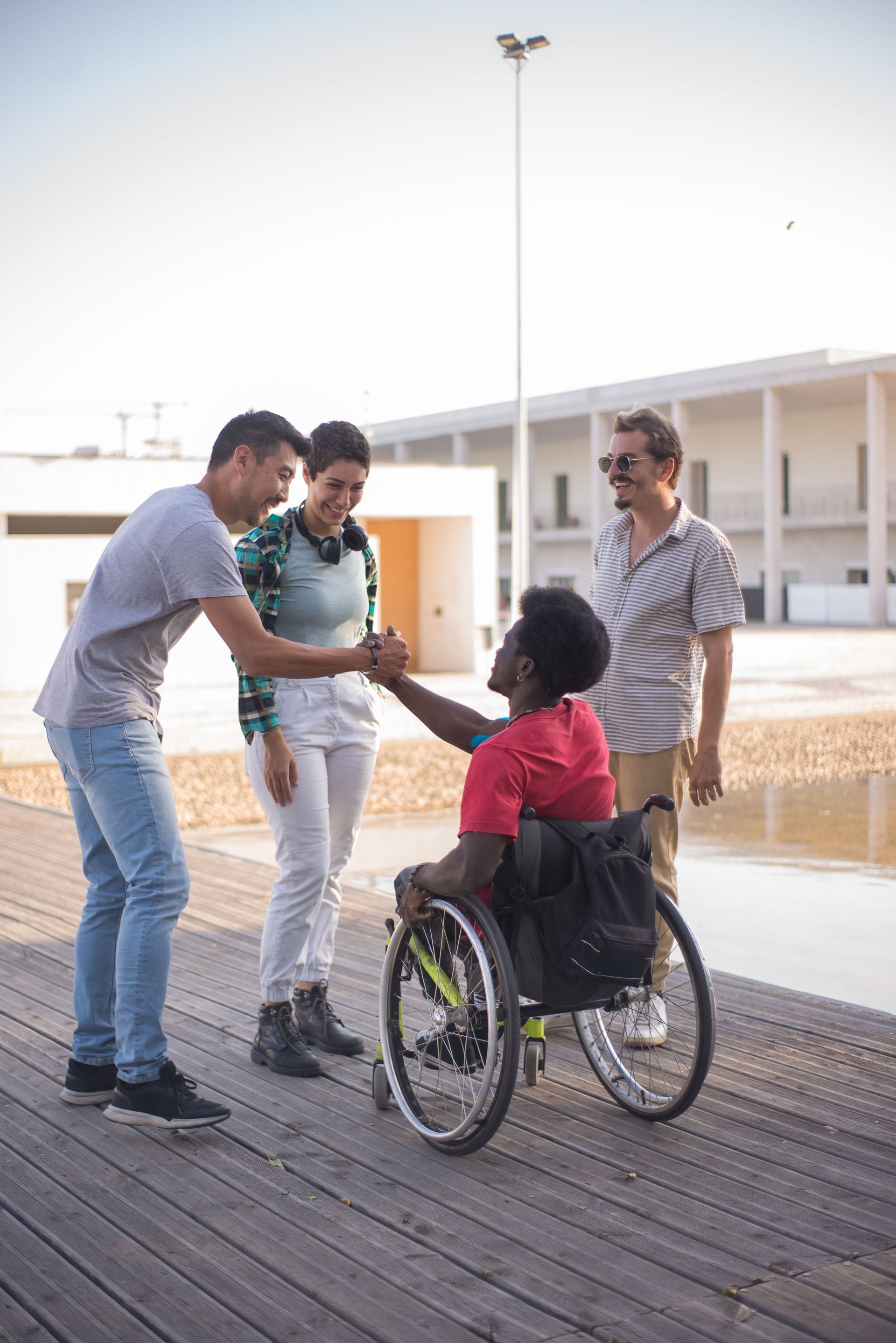 Three adults talking together outside a community building
