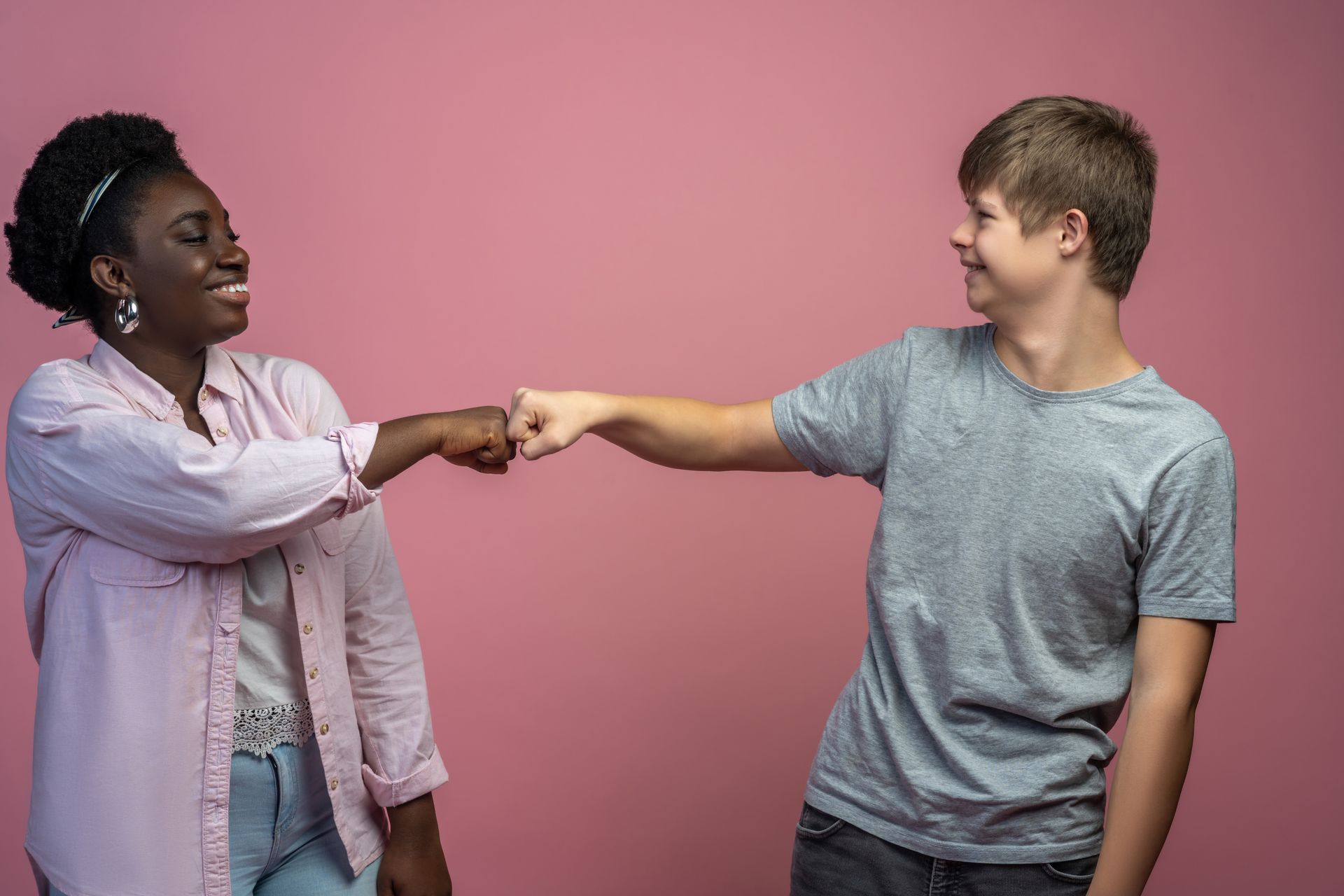 A man and a woman are giving each other a high five.