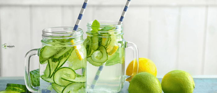 A refreshing glass of water with lemon, cucumber, and mint to support natural hydration and detoxification.