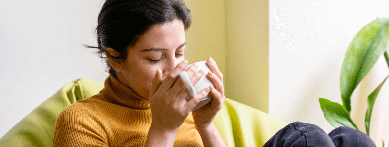 A woman sipping Tea while intermittently fasting