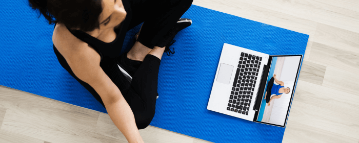 A woman practicing effective mindful movements with an online instructor