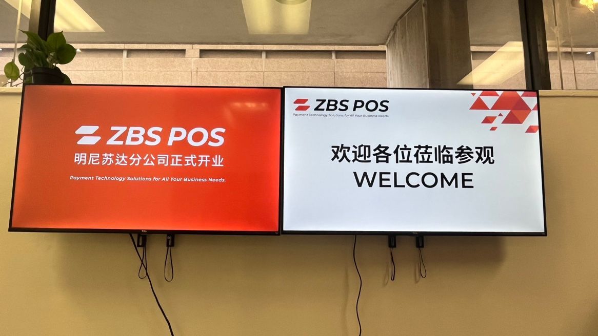 2 tv screen displaying ZBS POS welcome sign for office grand opening.