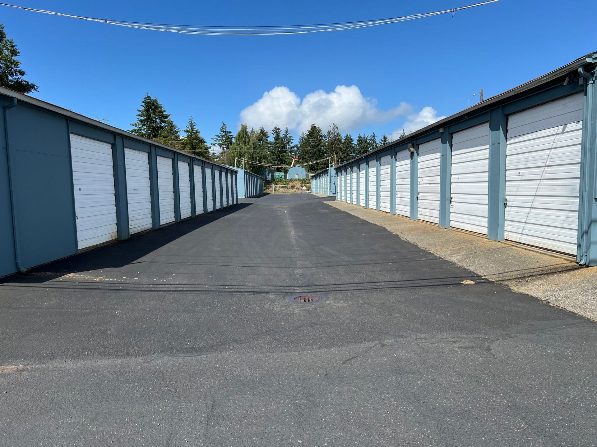 A row of storage units are lined up on the side of a road.