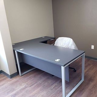 There is a desk and chair in the room.