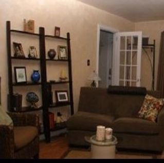A living room with a couch a chair and a coffee table