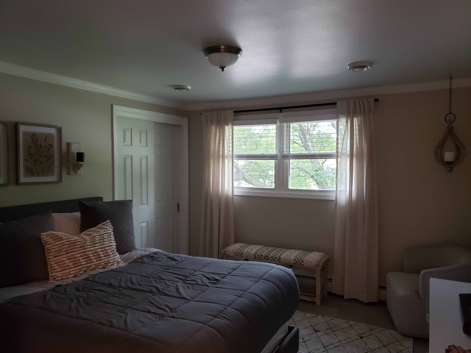 A bedroom with a large bed and a window