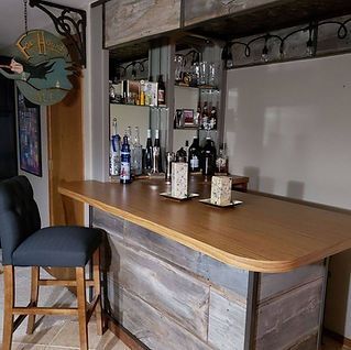 A bar with a wooden table and chairs in a living room.