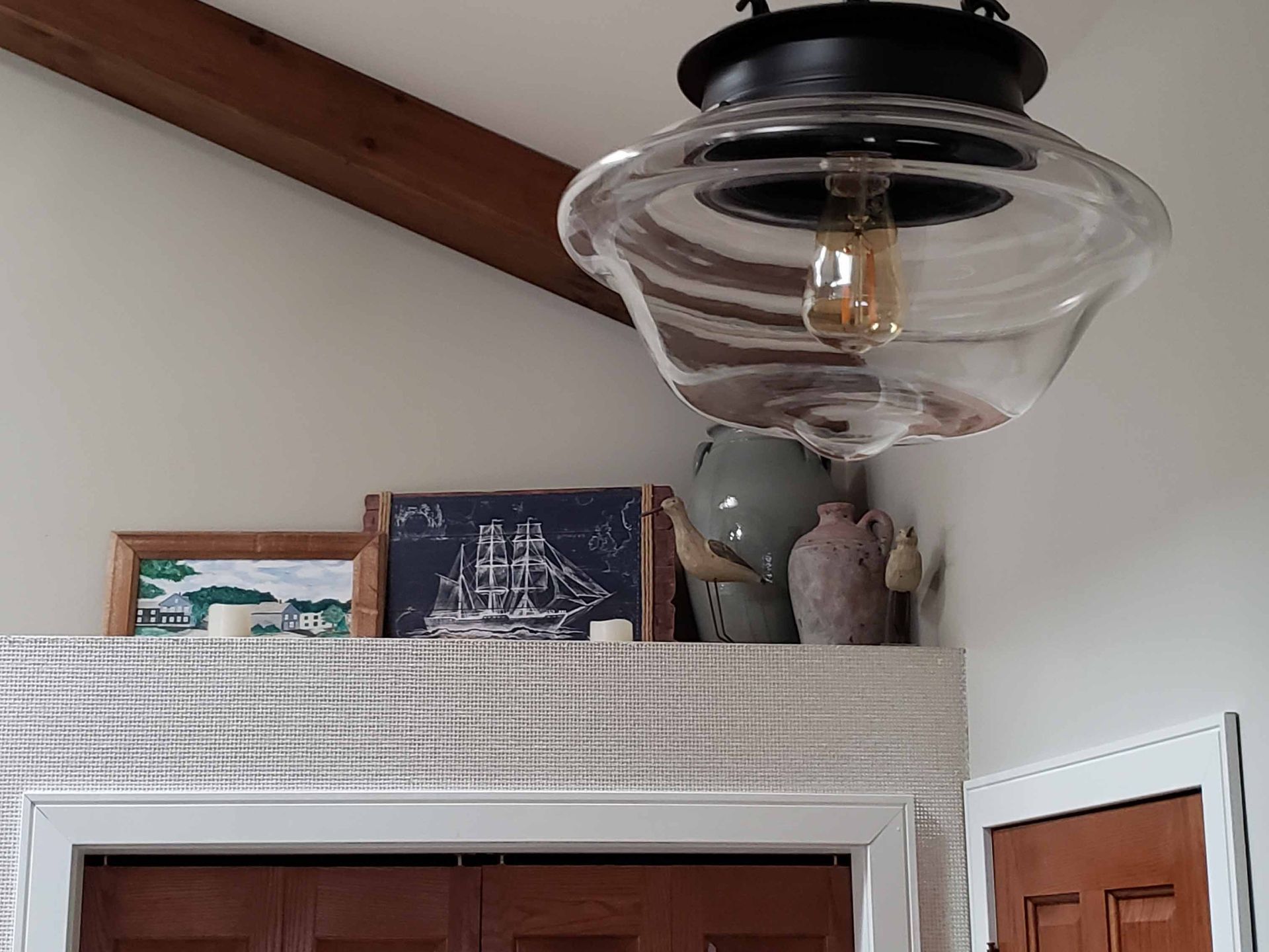 A light fixture is hanging from the ceiling in a room