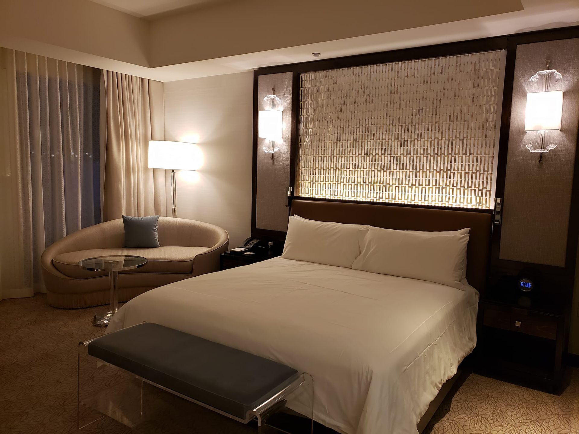 A hotel room with a large bed and a couch.