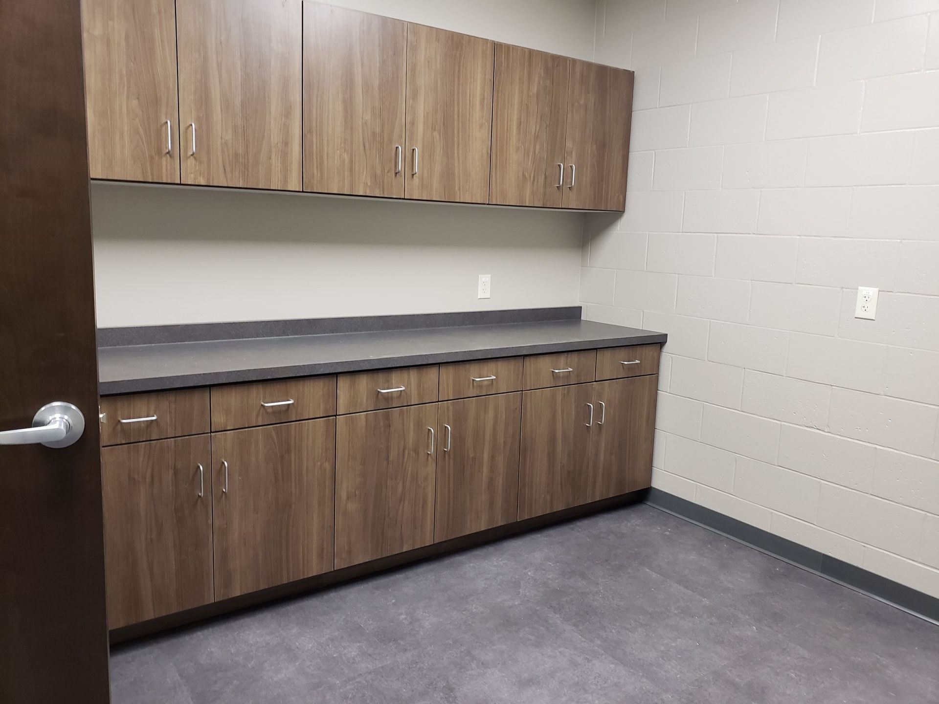 A kitchen with wooden cabinets and a counter top.