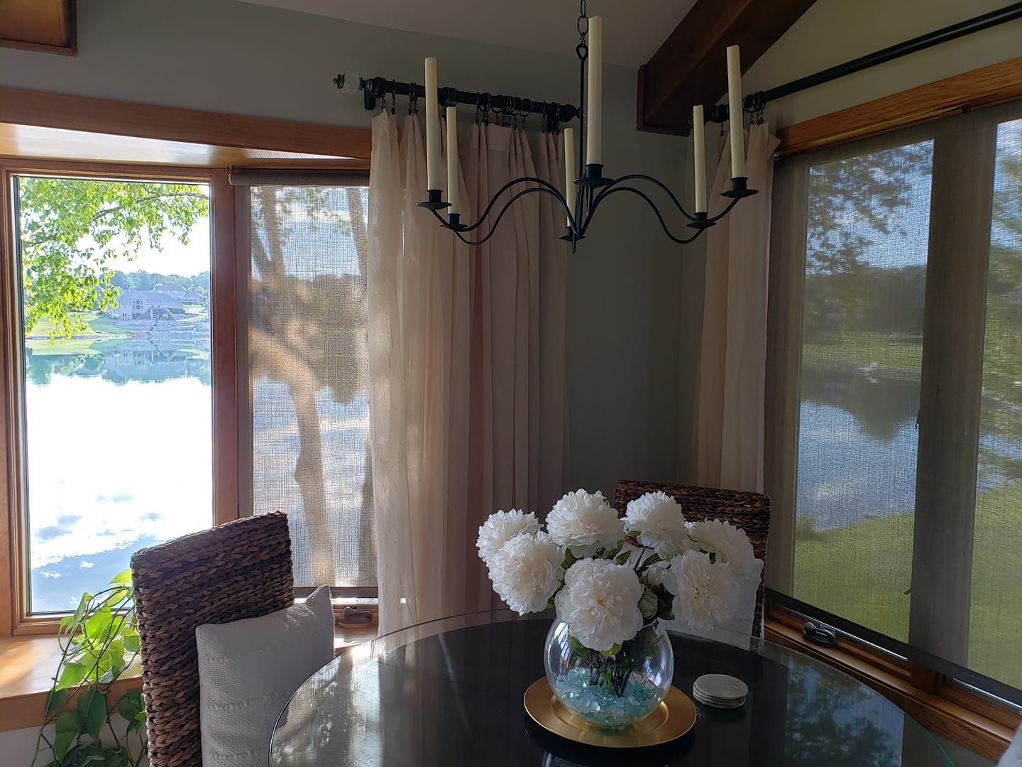 There is a vase of flowers on the table in the dining room.