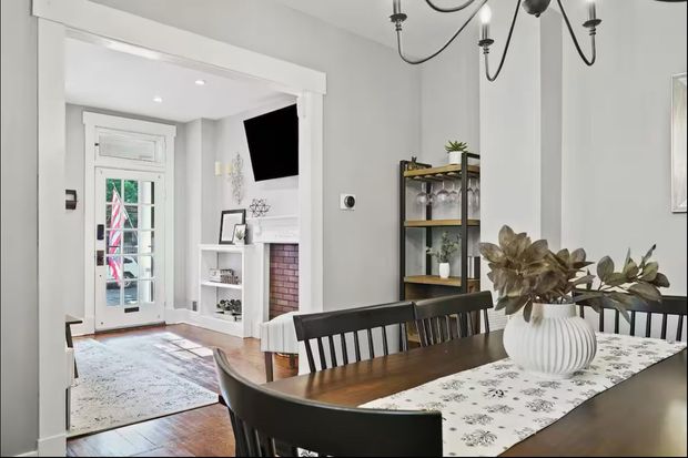 A dining room with a table and chairs and a chandelier.