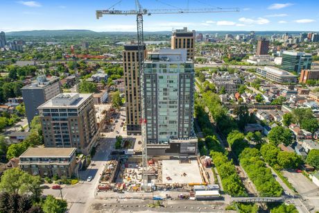 An aerial view of a city with a tall building under construction.