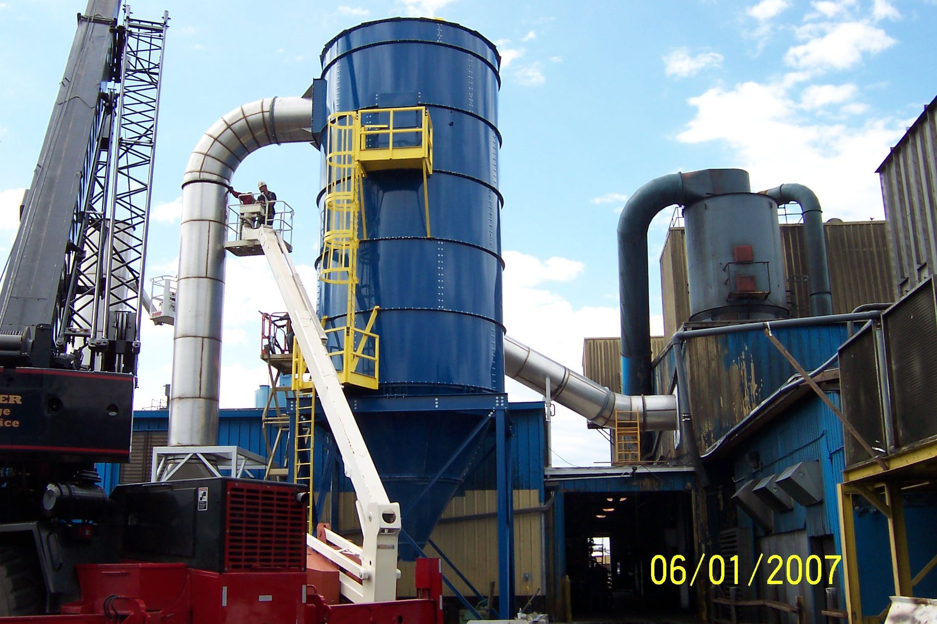 A photo taken on 06/01/2007 shows a crane in front of a building with industrial equipment. 