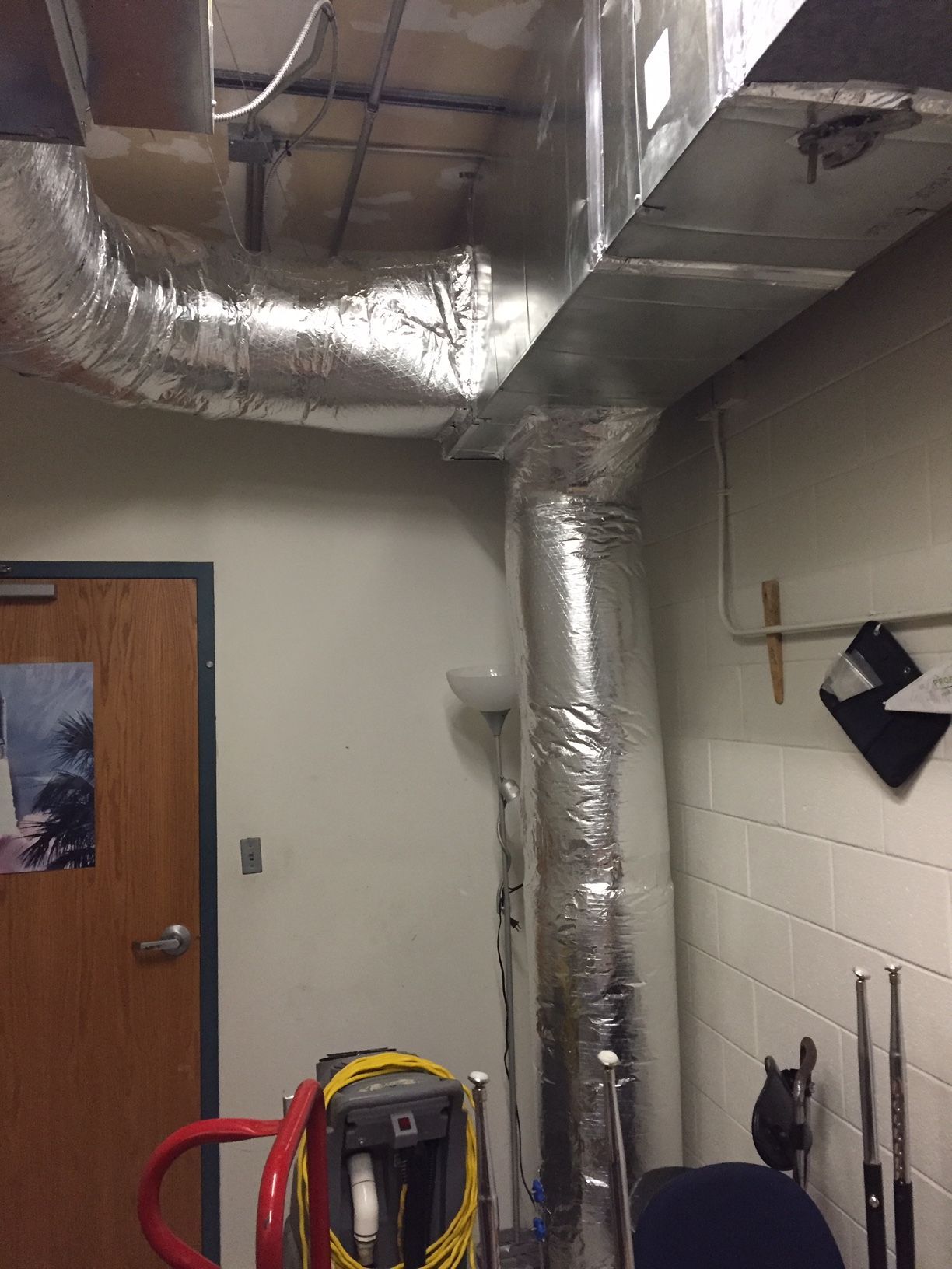 A room with a lot of pipes hanging from the ceiling.